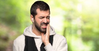 Sport man with toothache in a park