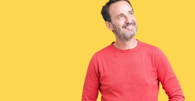 Handsome middle age hoary senior man wearing winter sweater over isolated background smiling looking side and staring away thinking.