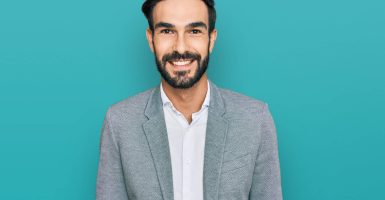Young hispanic man wearing business clothes with a happy and cool smile on face. lucky person.